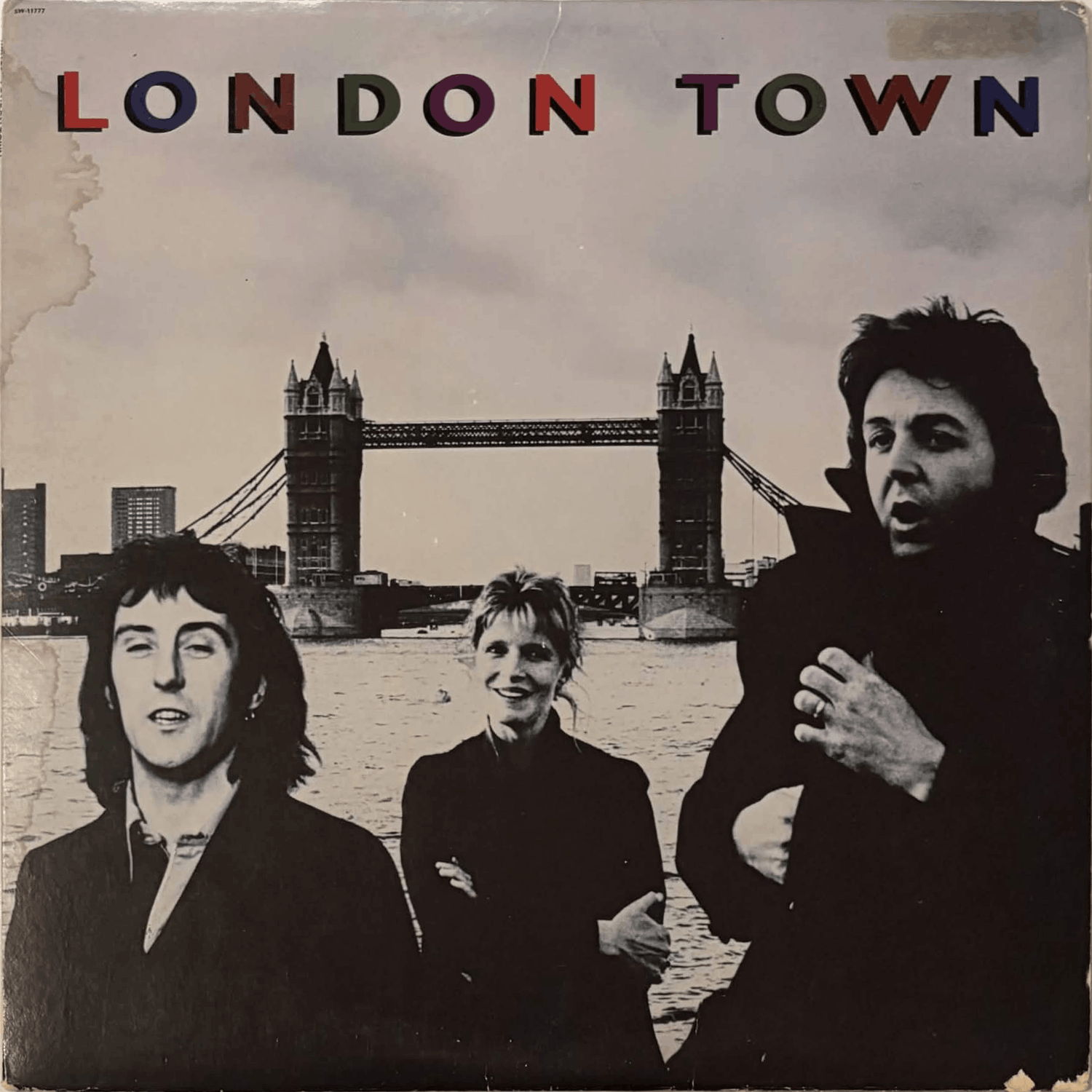 Album cover has some water damage and discoloration from a sticker.