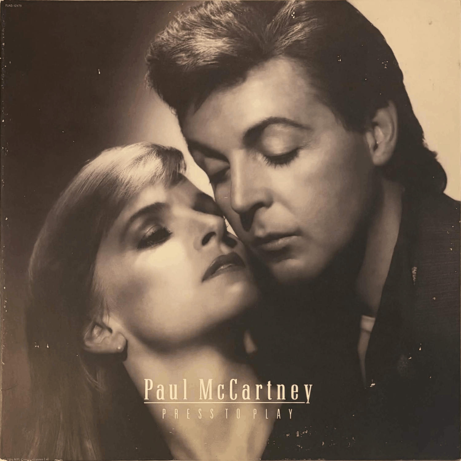 Album cover has light scuff marks.