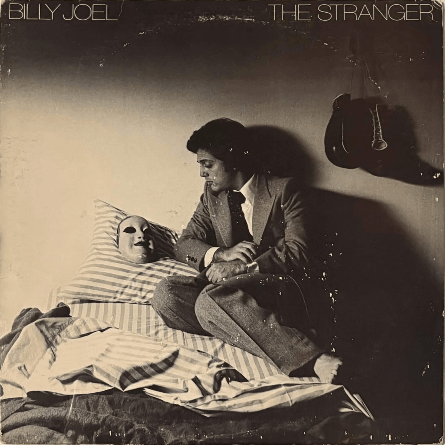 Album cover has ring wear and small damage marks.