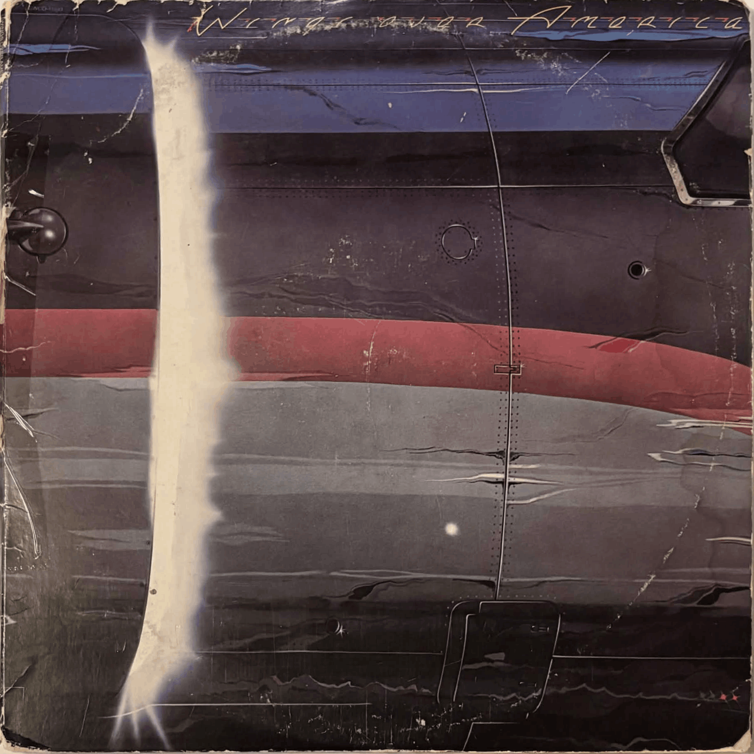 Album cover is very tattered, with noticeable ring wear. A piece of tape is attached to the spine.